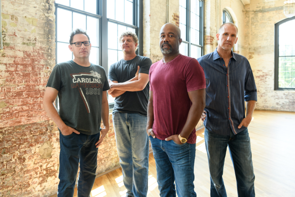 Hootie & the Blowfish stand in a room